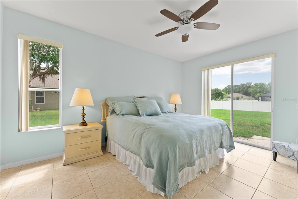 3149 Twisted Oak Loop Kissimmee, FL 34744 - Photo 18 of 52 a bedroom with a bed and a large window