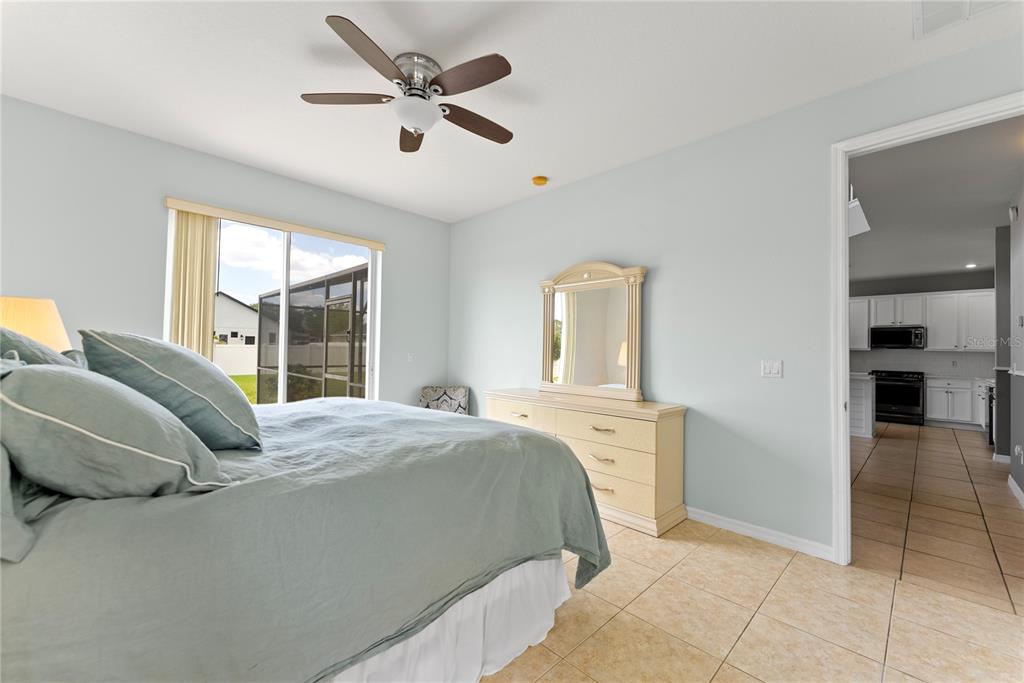 3149 Twisted Oak Loop Kissimmee, FL 34744 - Photo 19 of 52 a bedroom with a bed and a large window