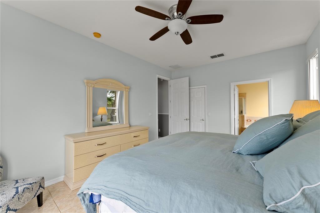 3149 Twisted Oak Loop Kissimmee, FL 34744 - Photo 20 of 52 a bedroom with a bed and a dresser