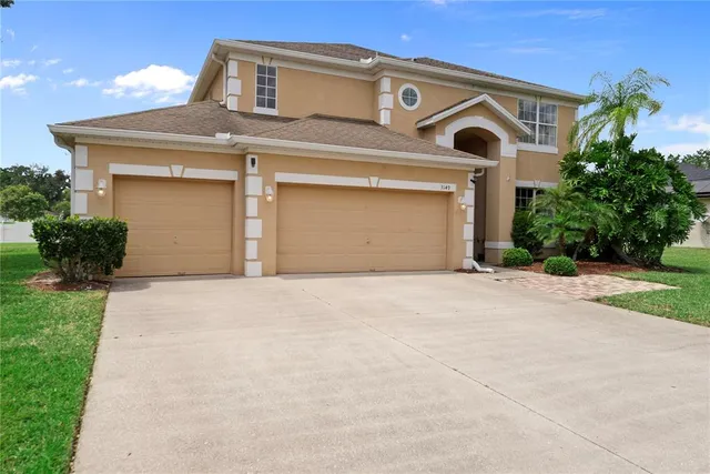 a front view of a house with a yard and garage