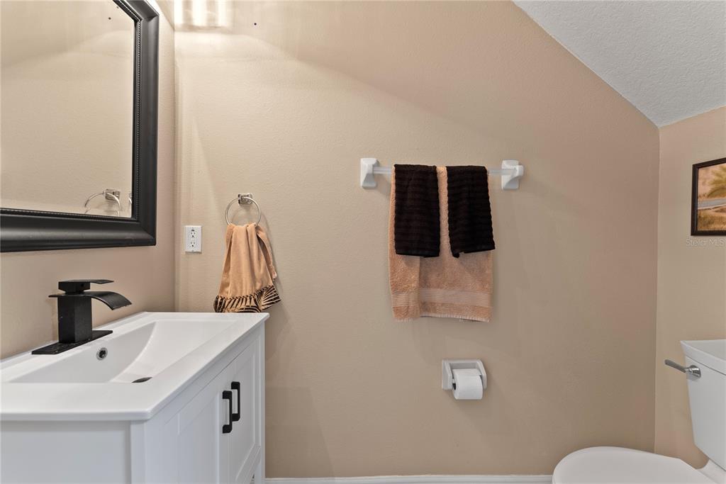 3149 Twisted Oak Loop Kissimmee, FL 34744 - Photo 24 of 52 a bathroom with a sink and a mirror