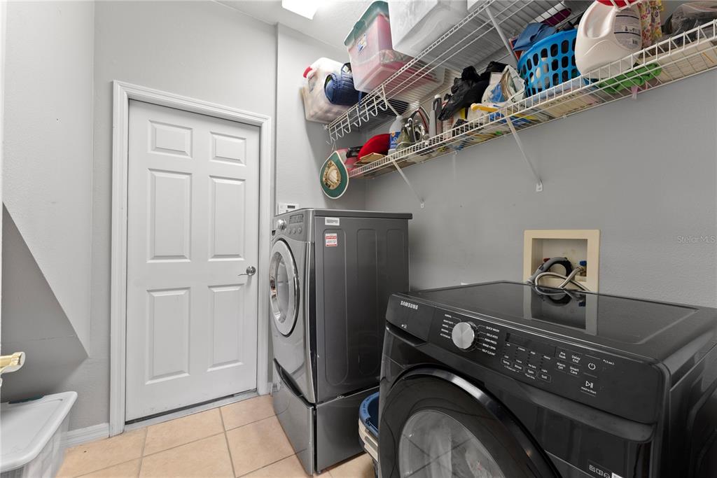 3149 Twisted Oak Loop Kissimmee, FL 34744 - Photo 25 of 52 a utility room with dryer and washer