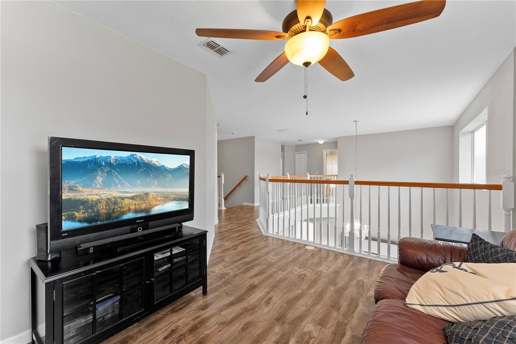3149 Twisted Oak Loop Kissimmee, FL 34744 - Photo 29 of 52 a living room with furniture and a flat screen tv