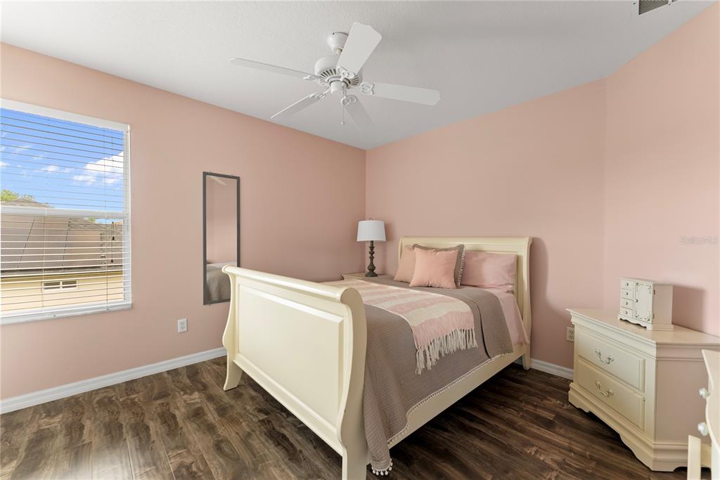 3149 Twisted Oak Loop Kissimmee, FL 34744 - Photo 30 of 52 a bed room with a bed and a chandelier