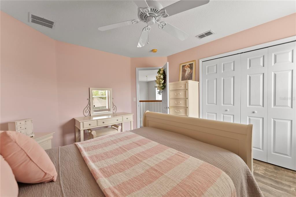 3149 Twisted Oak Loop Kissimmee, FL 34744 - Photo 31 of 52 a spacious bedroom with a bed and a chandelier