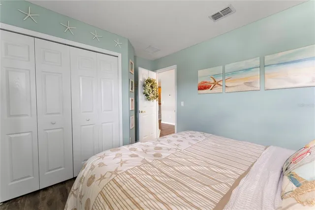 a bedroom with a bed and a potted plant