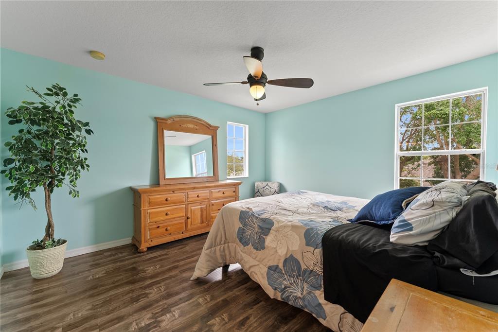 3149 Twisted Oak Loop Kissimmee, FL 34744 - Photo 34 of 52 a bedroom with a bed and a potted plant