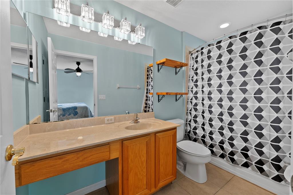 3149 Twisted Oak Loop Kissimmee, FL 34744 - Photo 36 of 52 a bathroom with a sink toilet and shower