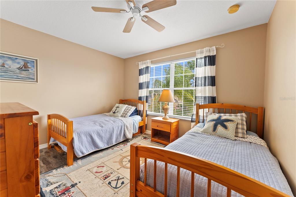 3149 Twisted Oak Loop Kissimmee, FL 34744 - Photo 39 of 52 a bedroom with two beds and wooden floor