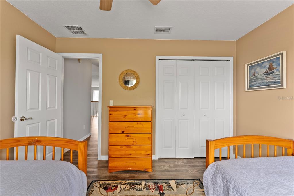 3149 Twisted Oak Loop Kissimmee, FL 34744 - Photo 40 of 52 a bedroom with a bed and a window