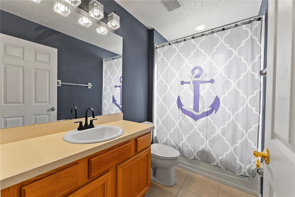 3149 Twisted Oak Loop Kissimmee, FL 34744 - Photo 41 of 52 a bathroom with a sink vanity mirror and toilet