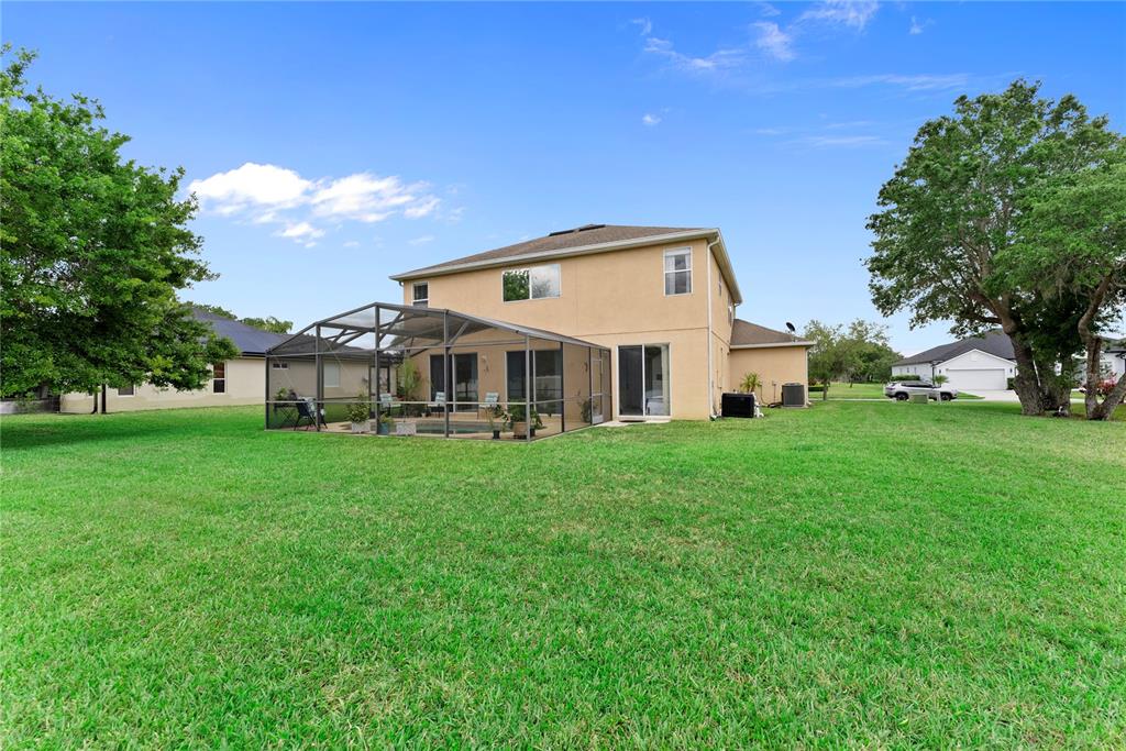 3149 Twisted Oak Loop Kissimmee, FL 34744 - Photo 47 of 52 a view of a house with backyard and garden