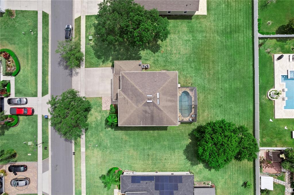 3149 Twisted Oak Loop Kissimmee, FL 34744 - Photo 48 of 52 an aerial view of a house with a yard and large trees
