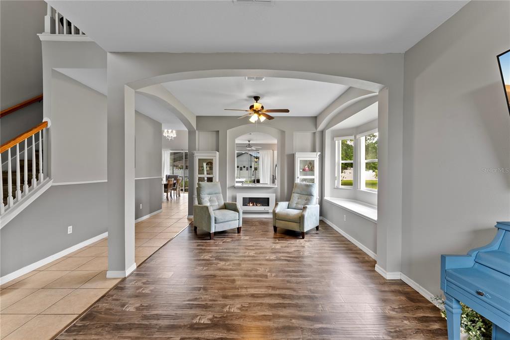 3149 Twisted Oak Loop Kissimmee, FL 34744 - Photo 5 of 52 a living room with furniture large window and wooden floor