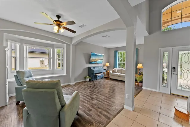 a living room with furniture and a chandelier