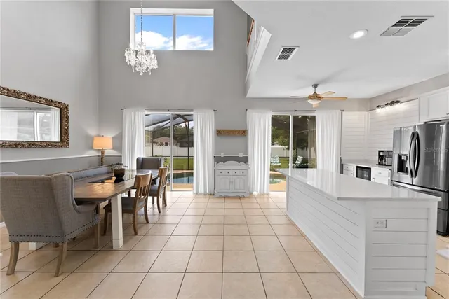 a view of a dining room with furniture and chandelier