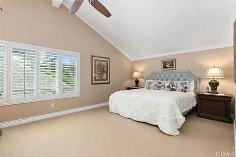 a bedroom with a bed and a large window