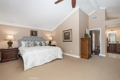 a spacious bedroom with a bed and a cabinets
