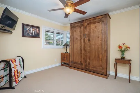 a view of a livingroom with furniture and a chandelier fan