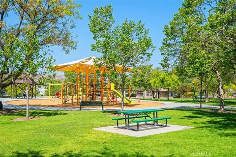 a view of pool with lawn chairs and umbrella
