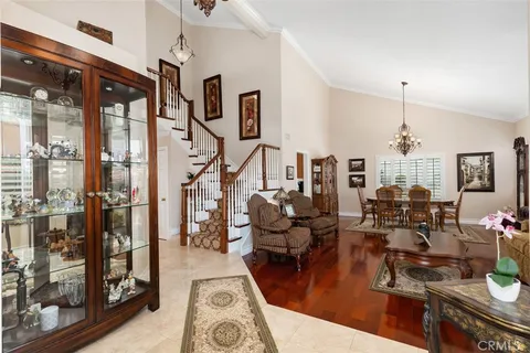 a very nice looking living room with furniture and a chandelier