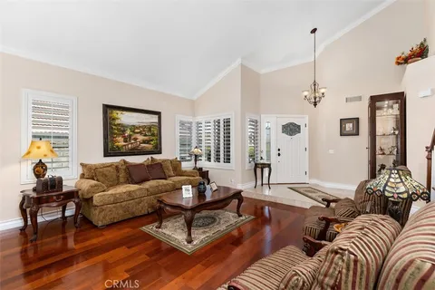 a living room with furniture or couch and a chandelier