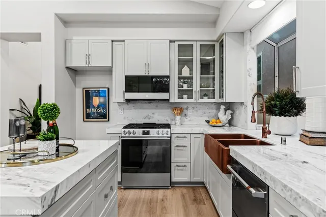 a kitchen with kitchen island granite countertop a sink stove and cabinets
