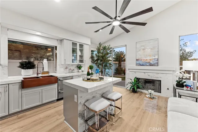 a living room with furniture a fireplace and a large window