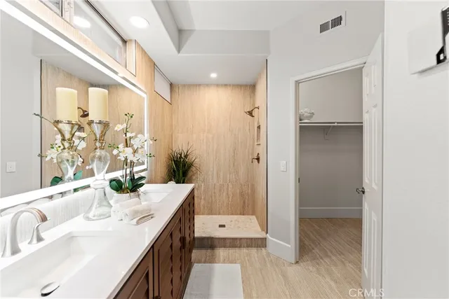 a bathroom with a granite countertop sink a shower and a mirror