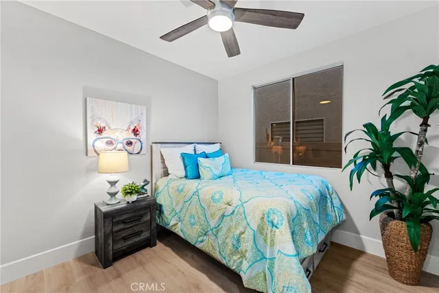 a bedroom with bed and a potted plant