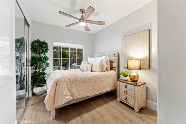 a bedroom with a bed a mirror and a window