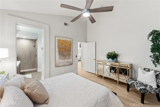 a bedroom with a bed a window and a chandelier