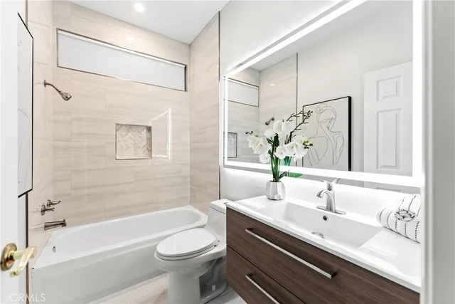 a bathroom with a bathtub shower sink and toilet