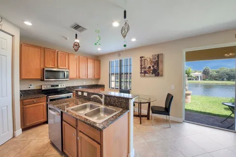 a kitchen that has a sink a stove top oven a counter space and cabinets