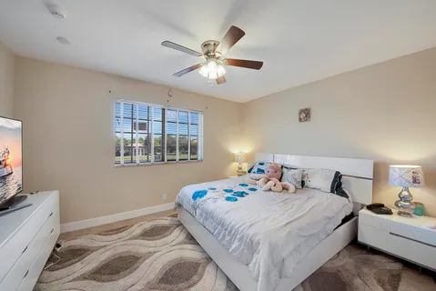 a bedroom with a large bed and a window