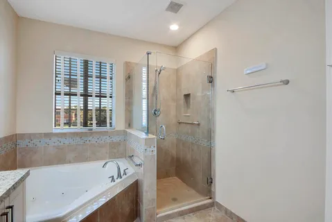 a bathroom with a bathtub a shower and a sink