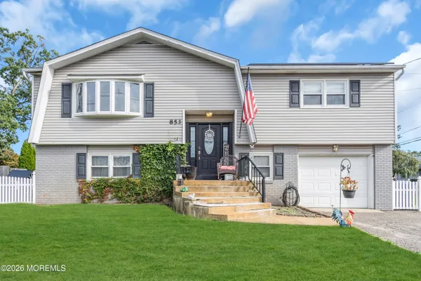 a front view of house with yard and outdoor seating