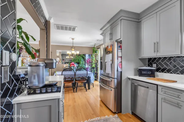 a kitchen with stainless steel appliances a stove a refrigerator and a stove top oven
