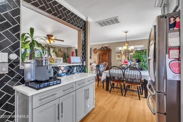 a dining room filled with furniture and wooden floor