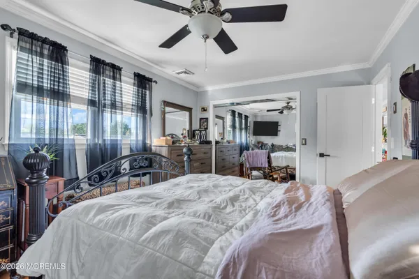 a bed room with a bed and a large mirror
