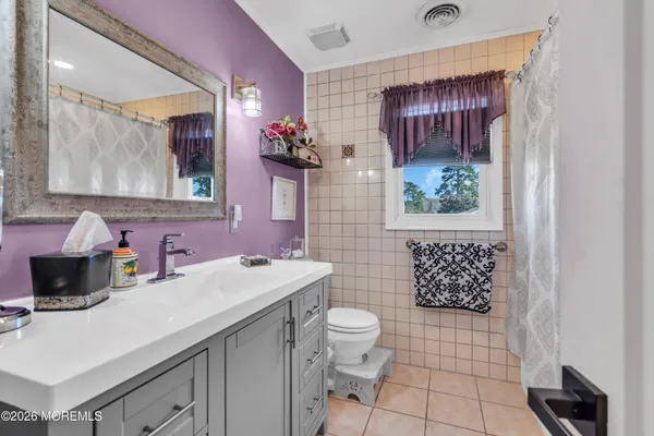 a bathroom with a sink toilet and mirror