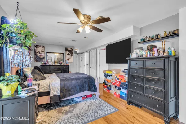 a bed room with a bed window and a flat screen tv