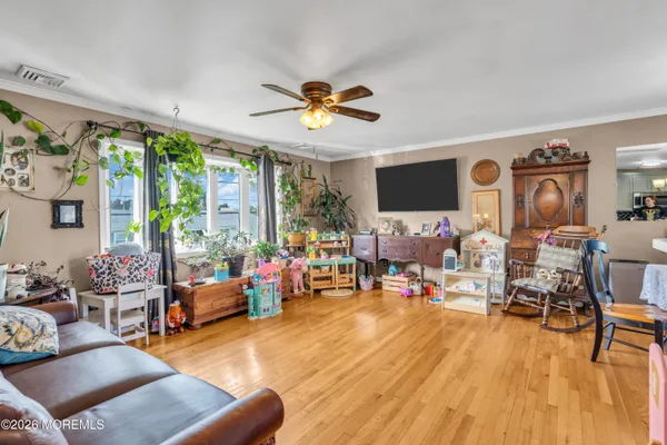 a living room filled with furniture and a flat screen tv