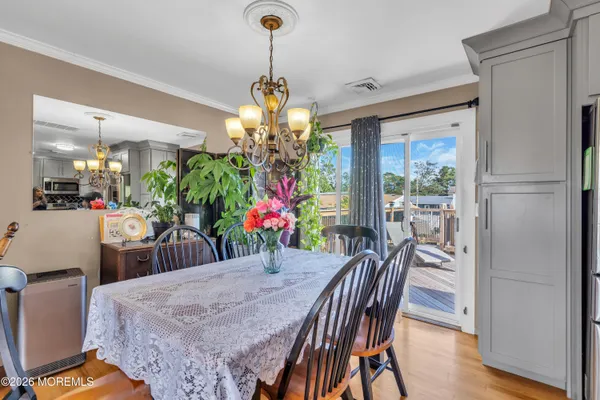 a view of a dining room with furniture and chandelier