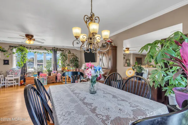 a view of a dining room with furniture and a chandelier
