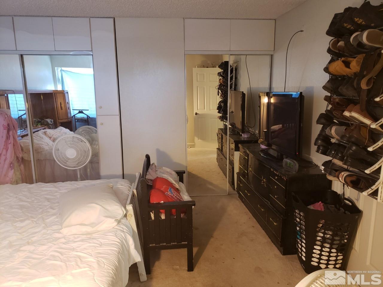 10044 Humite Lane Reno, NV 89506 - Photo 12 of 24 a bedroom with a bed and wooden floor