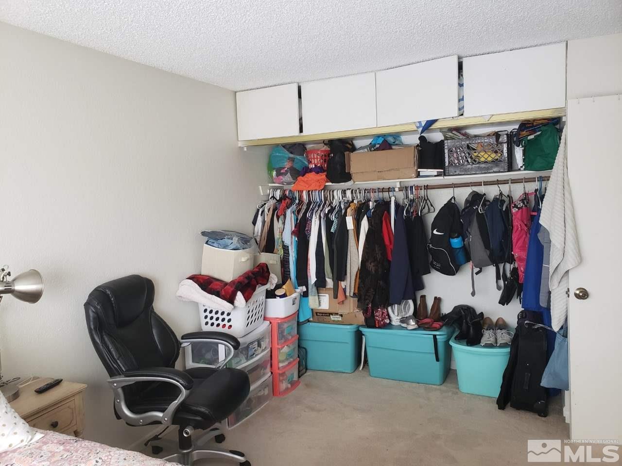 10044 Humite Lane Reno, NV 89506 - Photo 14 of 24 a view of walk in closet with clothes and shoes