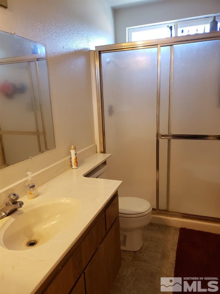 10044 Humite Lane Reno, NV 89506 - Photo 19 of 24 a bathroom with a sink toilet and shower
