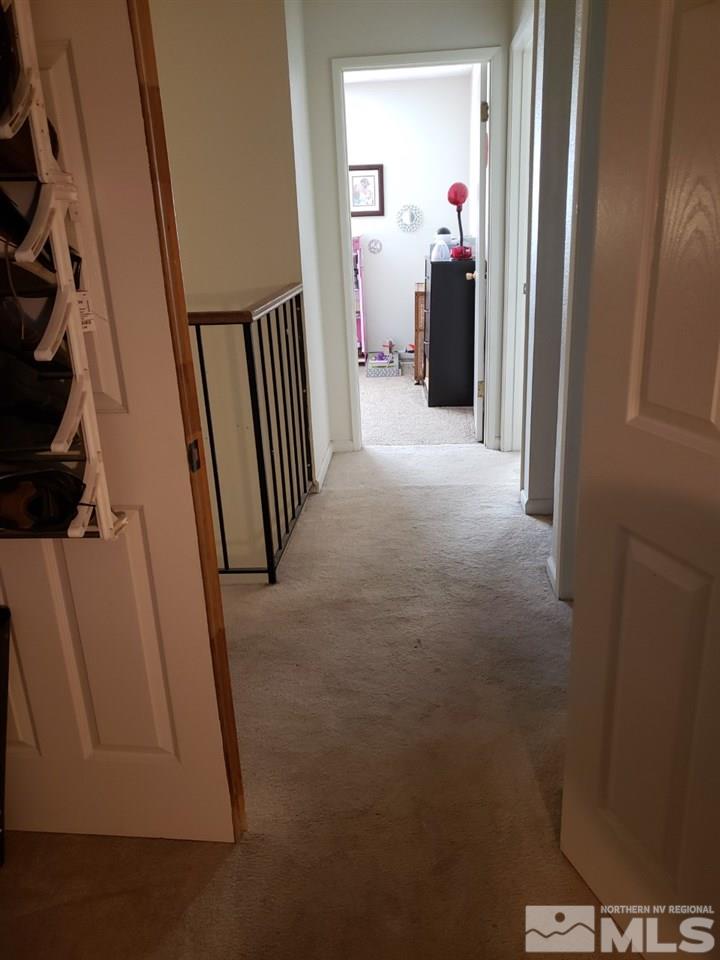 10044 Humite Lane Reno, NV 89506 - Photo 22 of 24 a view of a hallway view with wooden floor and staircase