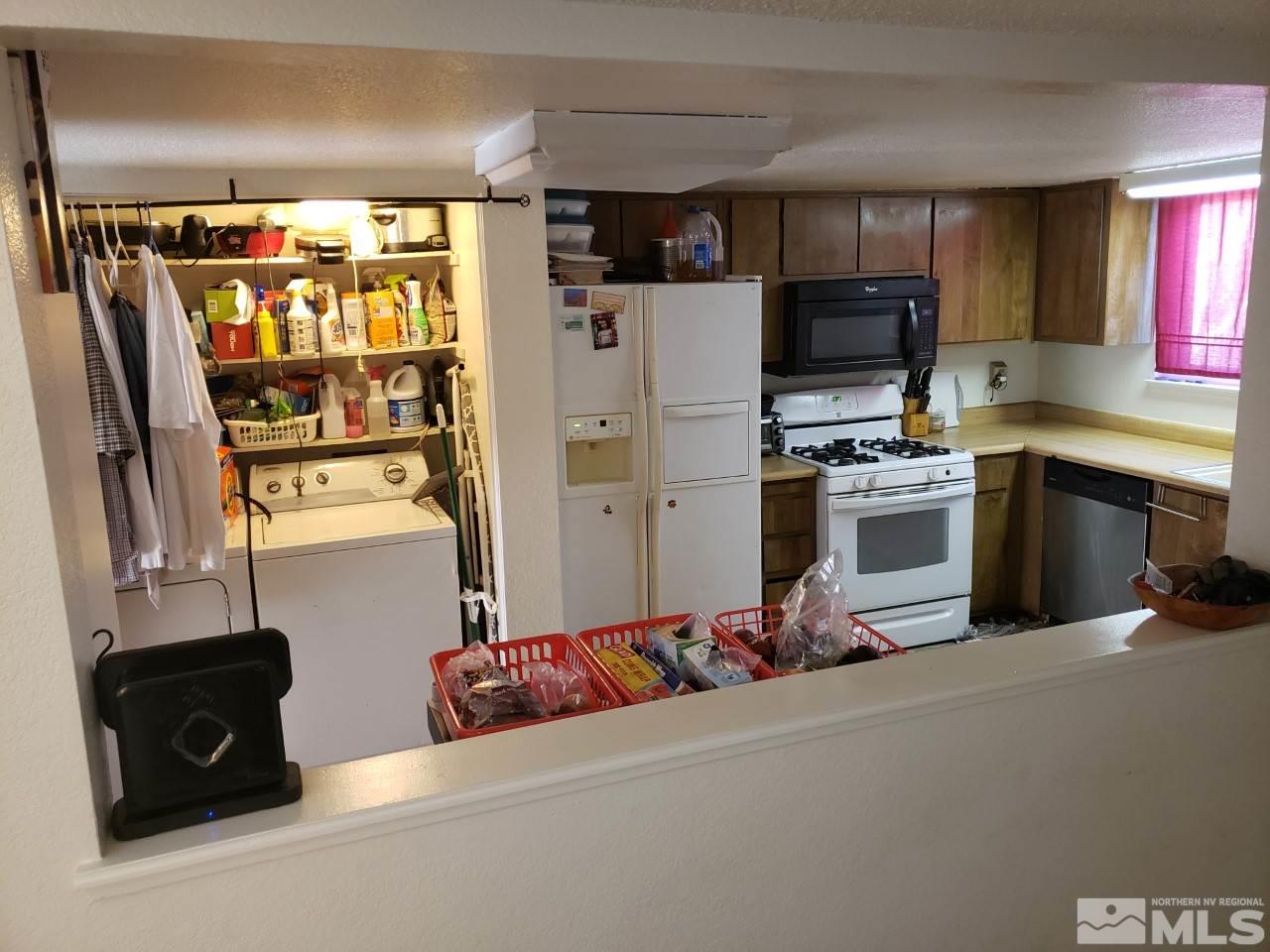 10044 Humite Lane Reno, NV 89506 - Photo 8 of 24 a kitchen with refrigerator and window